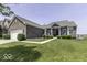 Beautiful brick home featuring a meticulously maintained lawn, inviting front porch, and ample parking space at 8864 S Tibbs Ave, Indianapolis, IN 46217
