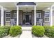 Inviting porch with rocking chairs, brick columns, and manicured greenery offering a warm welcome to visitors at 8864 S Tibbs Ave, Indianapolis, IN 46217
