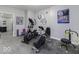Home gym featuring various exercise machines and motivational sports decor for an active lifestyle at 8864 S Tibbs Ave, Indianapolis, IN 46217