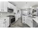 Well-appointed kitchen featuring white cabinetry, stainless steel appliances, and ample counter space at 8864 S Tibbs Ave, Indianapolis, IN 46217