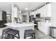 Modern kitchen with white cabinets, stainless steel appliances, and center island at 8864 S Tibbs Ave, Indianapolis, IN 46217