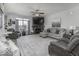 Spacious living room with a stone fireplace, plush seating, and plenty of natural light for a comfortable atmosphere at 8864 S Tibbs Ave, Indianapolis, IN 46217