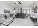 Open-concept living room boasting stylish furnishings, a stone accent wall, and seamless flow into the dining area at 8864 S Tibbs Ave, Indianapolis, IN 46217