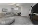 Comfortable living room features plush seating, a ceiling fan, and a large screen television for relaxing entertainment at 8864 S Tibbs Ave, Indianapolis, IN 46217
