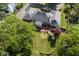 Aerial shot of backyard with deck, manicured lawn, mature trees providing shade and privacy at 9420 N Kenwood Ave, Indianapolis, IN 46260