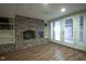 A rec room in the basement with a brick fireplace and white-framed doors at 9420 N Kenwood Ave, Indianapolis, IN 46260
