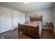 Bright bedroom showcasing a wooden bed frame, adjacent nightstand, and a white wardrobe at 9420 N Kenwood Ave, Indianapolis, IN 46260