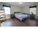 Bedroom with hardwood floors, natural light, decorative plants, and blue bedding at 9420 N Kenwood Ave, Indianapolis, IN 46260