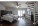 Bedroom with spiral stairs, hardwood floors, and decorative ceiling fan at 9420 N Kenwood Ave, Indianapolis, IN 46260