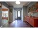 Inviting entryway with wood floors, gray walls, an elegant buffet, and a view of the front door at 9420 N Kenwood Ave, Indianapolis, IN 46260