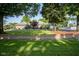 Charming single-story brick home with a beautiful lawn, mature trees, and a circular driveway at 9420 N Kenwood Ave, Indianapolis, IN 46260