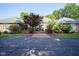 Stunning single-story brick home featuring manicured landscaping and a paved walkway leading to the entrance at 9420 N Kenwood Ave, Indianapolis, IN 46260