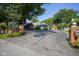 Home's front exterior showcasing a brick house, circular driveway, landscaped entrance, and mature trees at 9420 N Kenwood Ave, Indianapolis, IN 46260