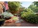 Landscaped front yard featuring shrubs, flowers, and a stone bench for enjoying the outdoors at 9420 N Kenwood Ave, Indianapolis, IN 46260