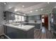 Charming kitchen features stylish gray cabinetry, tile counters and backsplash, and modern track lighting at 9420 N Kenwood Ave, Indianapolis, IN 46260