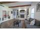 Inviting living room featuring a brick fireplace, built-in shelves, and a comfortable gray sofa at 9420 N Kenwood Ave, Indianapolis, IN 46260