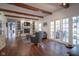 Spacious living room with exposed wood beams, brick fireplace, and French doors for a bright interior at 9420 N Kenwood Ave, Indianapolis, IN 46260