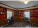 Home office features built-in shelving, dual work stations, and wood trim throughout the room at 9420 N Kenwood Ave, Indianapolis, IN 46260