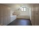Bright walk-in closet featuring built-in bench seating, cabinets and a large window at 9420 N Kenwood Ave, Indianapolis, IN 46260