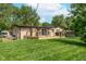 Picture of the backyard showing a deck with outdoor furniture surrounded by a well-maintained lawn at 10622 Penn Dr, Indianapolis, IN 46280