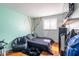 Unique bedroom showcasing a tree mural, dark beanbag chair, and a window with natural light at 10622 Penn Dr, Indianapolis, IN 46280