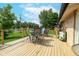 Wooden deck furnished with a dining set with a lawn and plants in background on a sunny day at 10622 Penn Dr, Indianapolis, IN 46280