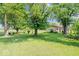 Lush backyard featuring mature trees and expansive grassy area at 10928 W Jackson St, Muncie, IN 47304
