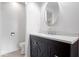 Modern bathroom vanity with sleek dark wood cabinets and a stylish round mirror at 10928 W Jackson St, Muncie, IN 47304
