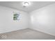 Neutral bedroom with grey carpet, white walls, and a single window at 10928 W Jackson St, Muncie, IN 47304