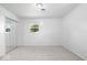 Neutral bedroom with grey carpet, white walls, mirrored closet and a single window at 10928 W Jackson St, Muncie, IN 47304