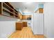 Traditional kitchen with wood cabinets, laminate countertops, and white appliances at 10928 W Jackson St, Muncie, IN 47304