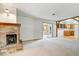 Bright living room featuring a brick fireplace and an open layout to the adjacent kitchen at 10928 W Jackson St, Muncie, IN 47304