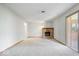 Large living room with a charming brick fireplace and sliding glass doors at 10928 W Jackson St, Muncie, IN 47304