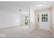 Bright and airy living room featuring neutral carpet, large windows, and stylish wall accents at 10928 W Jackson St, Muncie, IN 47304