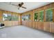 Spacious sunroom with wood paneling, large windows, and carpeted floors at 10928 W Jackson St, Muncie, IN 47304