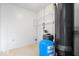 Utility room with water heater, pressure tank, and shelving at 10928 W Jackson St, Muncie, IN 47304