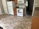 The kitchen has white appliances including a fridge, stove, and oven and medium colored cabinets at 1108 Pierce Dr, Plainfield, IN 46168