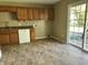 Sunny kitchen features laminate floors, ample cabinet space, and sliding doors leading to the backyard at 1108 Pierce Dr, Plainfield, IN 46168