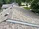 New roof with a varied color of brown and gray shingles with dark vents surrounded by lush green trees at 1108 Pierce Dr, Plainfield, IN 46168
