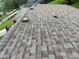 New roof with a varied color of brown and gray shingles with dark vents in a lush green neighborhood at 1108 Pierce Dr, Plainfield, IN 46168