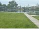 Green tennis courts surrounded by green grass, and a bicycle rack at 1108 Pierce Dr, Plainfield, IN 46168