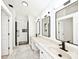 Modern bathroom featuring double sinks, quartz countertop, framed mirrors, and tiled shower at 11320 Lynchburg Way, Indianapolis, IN 46229