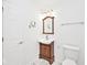 Bathroom with a charming wood vanity, decorative mirror and marble tile flooring at 11320 Lynchburg Way, Indianapolis, IN 46229
