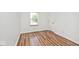 A bright room featuring wood-look floors and a window letting in natural light at 11320 Lynchburg Way, Indianapolis, IN 46229