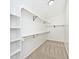 Organized walk-in closet with shelving and hanging rods for efficient storage solutions at 11320 Lynchburg Way, Indianapolis, IN 46229
