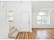Bright and spacious foyer with gleaming hardwood floors and a staircase leading to the upper level at 11320 Lynchburg Way, Indianapolis, IN 46229