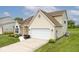 A well-maintained property with a spacious two-car garage, complemented by a beautiful lawn at 11320 Lynchburg Way, Indianapolis, IN 46229