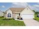 Charming single-Gathering home featuring a well-manicured lawn and a two-car garage at 11320 Lynchburg Way, Indianapolis, IN 46229