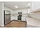 Well-equipped kitchen features stainless steel appliances, white cabinetry, and wood flooring, blending style with functionality at 11320 Lynchburg Way, Indianapolis, IN 46229