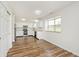 Spacious kitchen features stainless steel appliances, white cabinets, ample counter space, and wood flooring at 11320 Lynchburg Way, Indianapolis, IN 46229